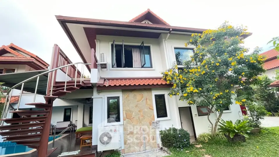 Charming two-story house with lush garden and spiral staircase, perfect for family living.