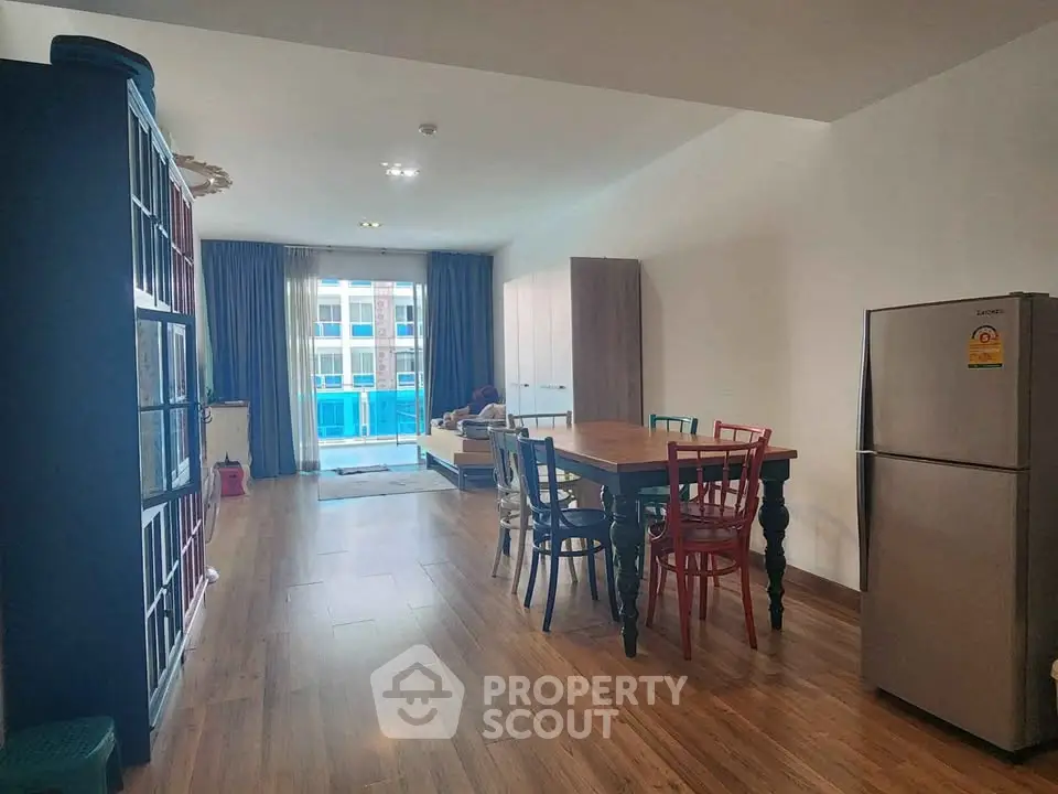 Spacious open-plan living and dining area with modern decor and natural light.
