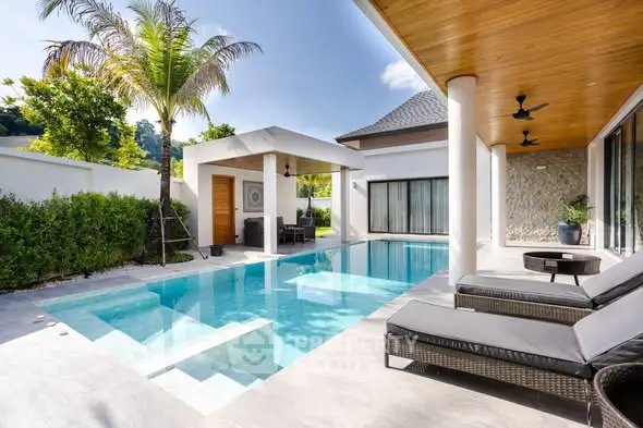 Luxurious modern villa with private pool and sun loungers, perfect for relaxation and entertaining.