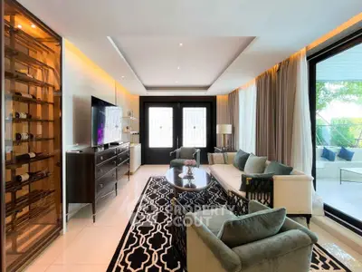 Luxurious living room with elegant furniture and large windows overlooking a serene garden.