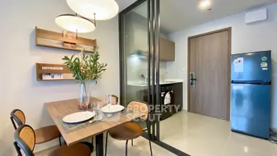 Modern kitchen and dining area with sleek design and contemporary lighting.