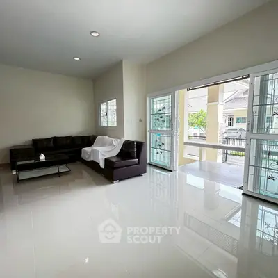 Spacious modern living room with sleek furniture and large windows for natural light.