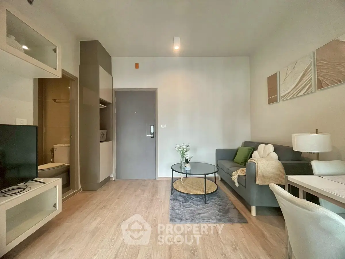 Modern living room with cozy sofa and stylish decor in a contemporary apartment.