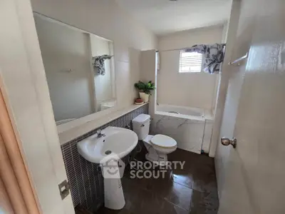 Modern bathroom with bathtub and sleek fixtures in a stylish home.
