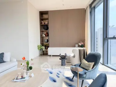 Luxurious modern living room with elegant decor and large windows offering abundant natural light.