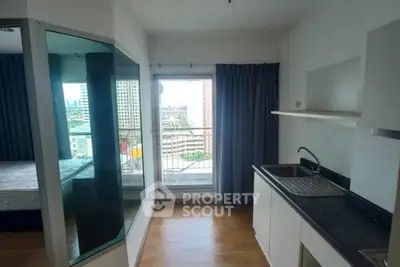 Modern apartment with compact kitchen and balcony view