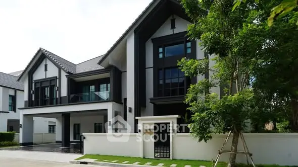 Luxurious modern house exterior with sleek design and lush greenery, perfect for upscale living.