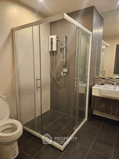 Modern bathroom with glass shower enclosure and sleek fixtures