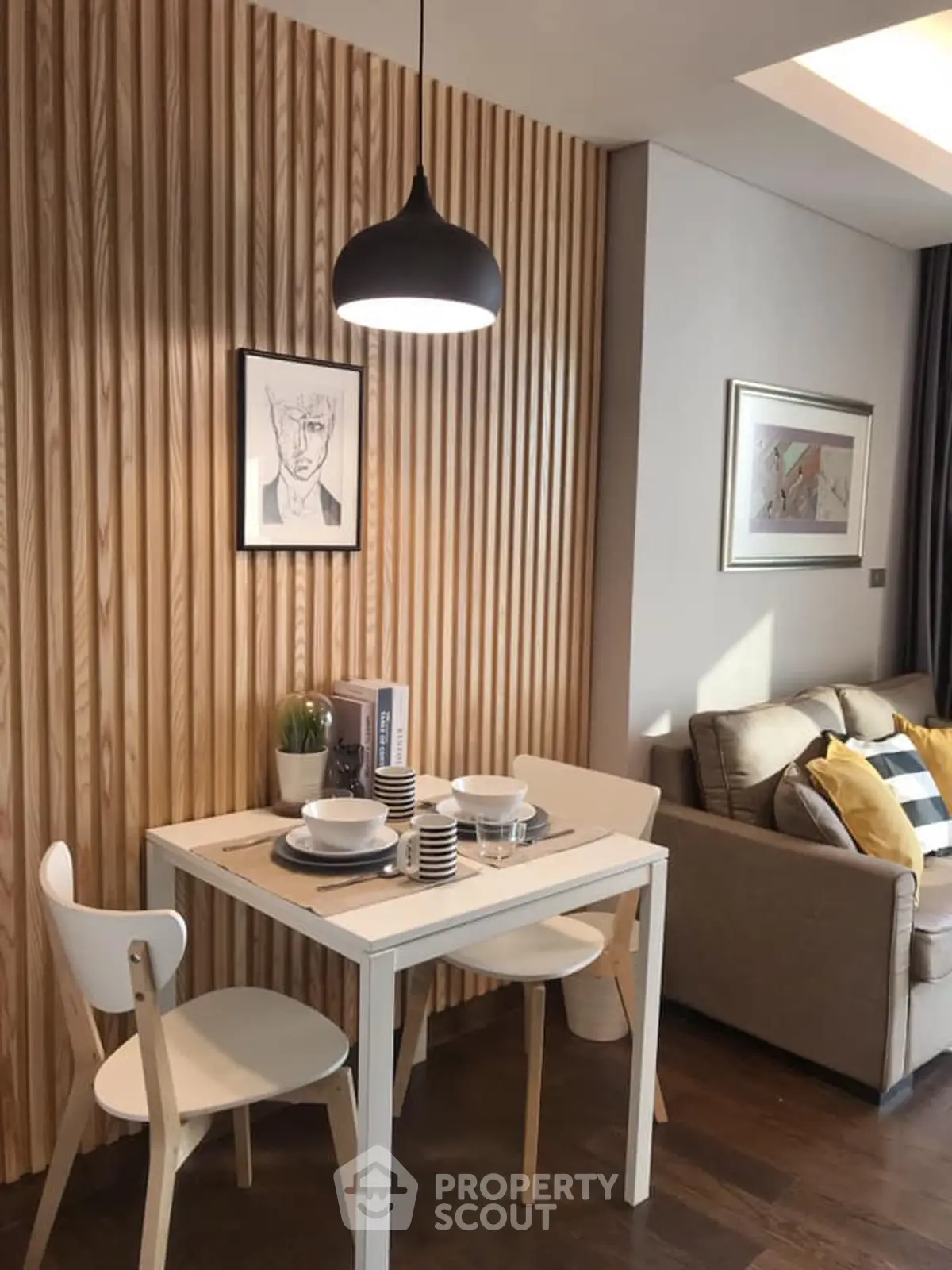 Chic modern living room with stylish dining area and cozy sofa, perfect for urban living.