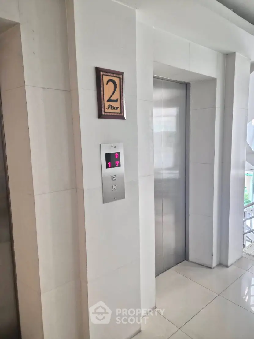 Modern building elevator lobby with sleek design on the second floor.