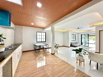 Spacious open-plan living room with modern kitchen and elegant decor