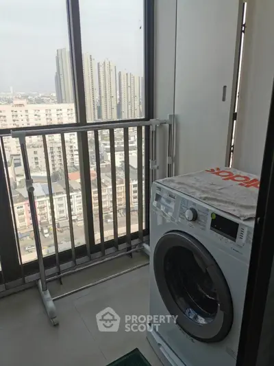 High-rise balcony with washing machine and city view, perfect for urban living.