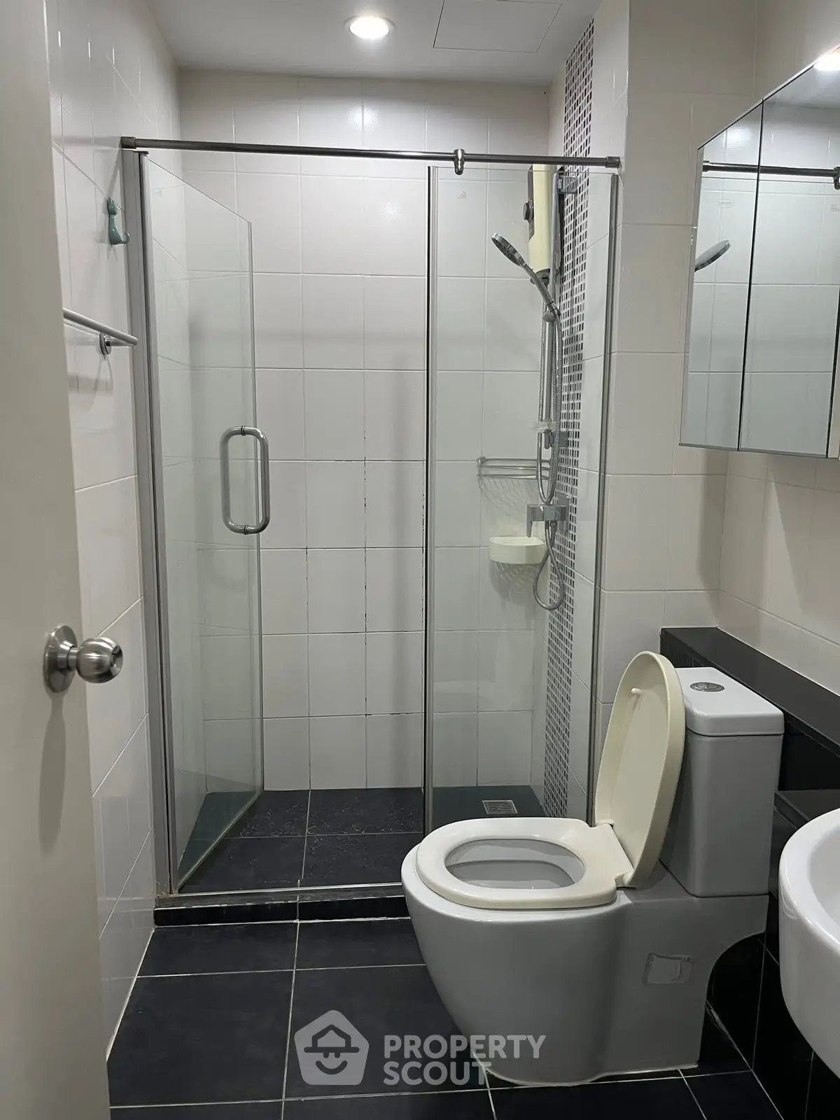 Modern bathroom with glass shower and sleek fixtures, perfect for a contemporary home.