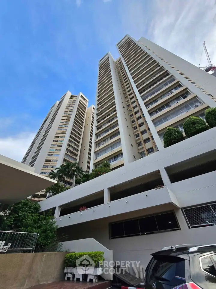 Stunning high-rise residential building with modern architecture and lush greenery.