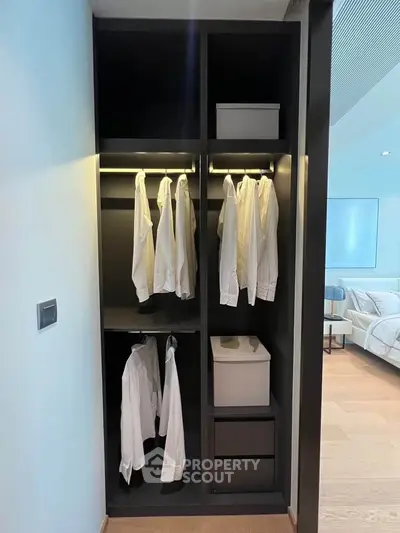 Modern open closet with hanging shirts in a stylish bedroom setting