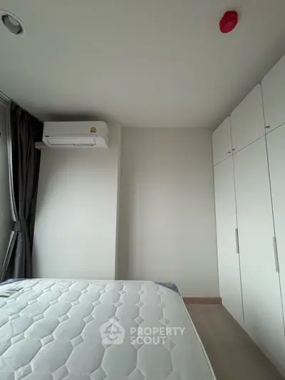 Modern bedroom with air conditioning and built-in wardrobe, perfect for comfortable living.