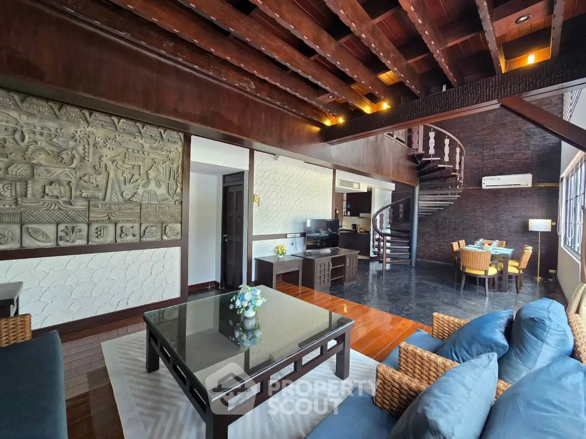 Luxurious living room with spiral staircase and elegant decor