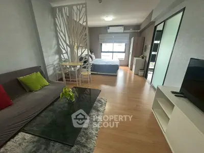 Modern open-plan studio apartment with stylish decor and natural light.