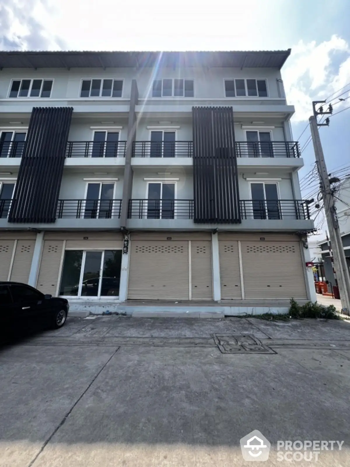 Modern multi-story building with sleek design and spacious balconies