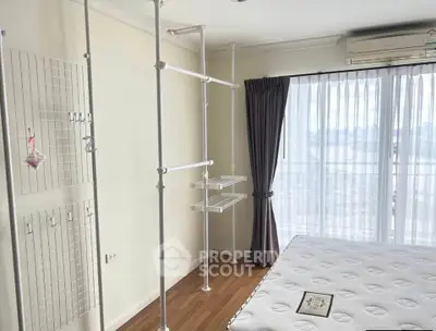 Bright bedroom with large window and modern storage solutions