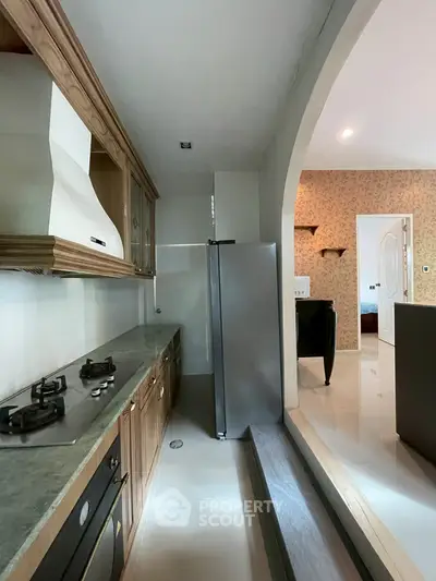 Charming kitchen with gas stove and elegant wooden cabinetry