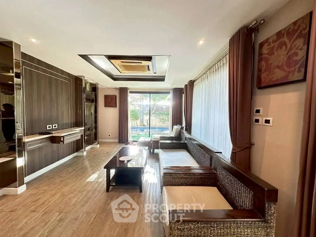 Spacious living room with modern decor and large windows offering natural light.