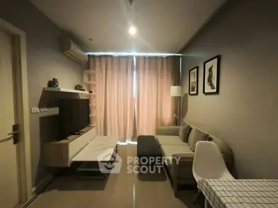 Modern living room with stylish decor, featuring a cozy sofa, wall-mounted TV, and elegant lighting.