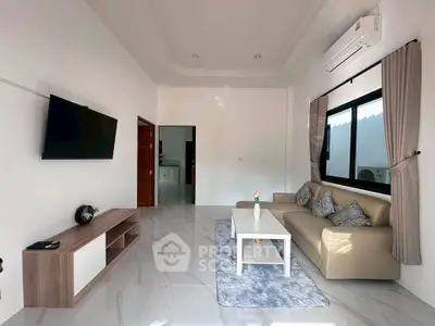 Modern living room with sleek furniture and large window, featuring a wall-mounted TV and air conditioning.