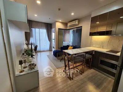Modern open-plan living room and kitchen with stylish decor and natural light.