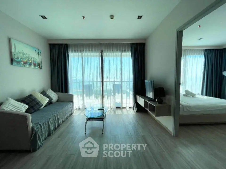 Spacious living room with modern decor and large windows offering natural light.