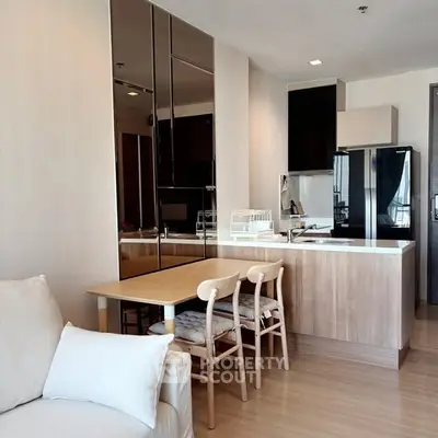 Modern kitchen with sleek design and dining area in open layout apartment