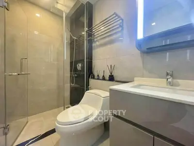 Modern bathroom with sleek fixtures and glass shower enclosure