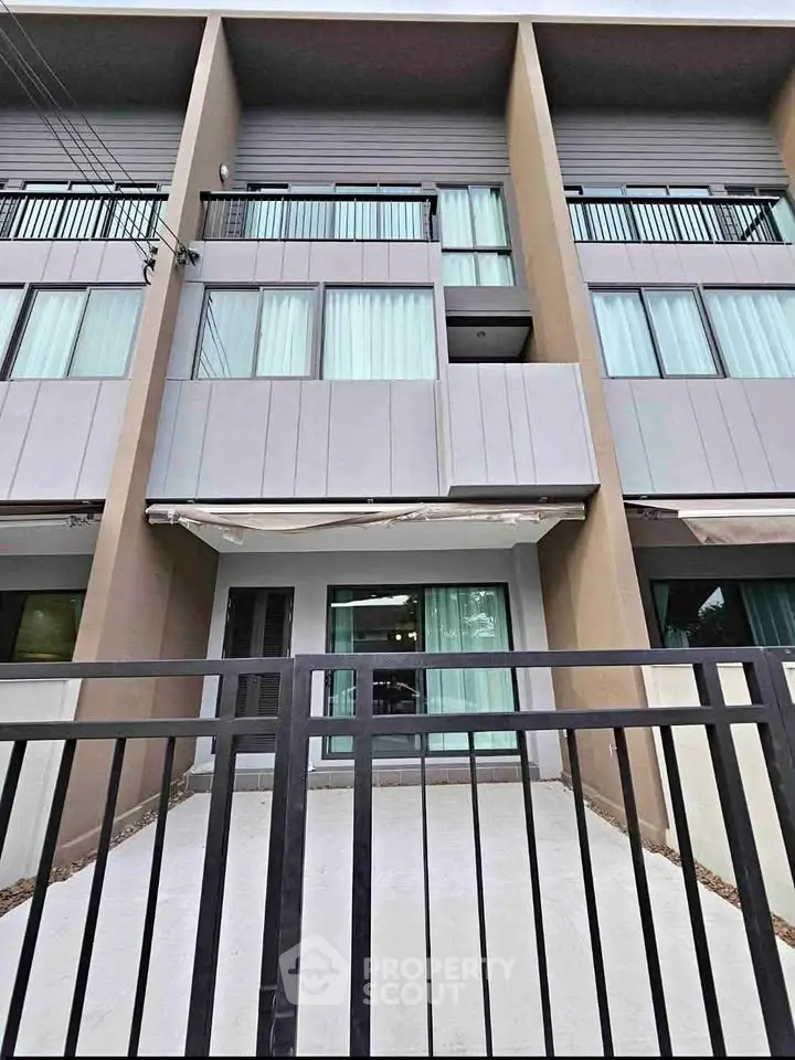 Modern townhouse exterior with sleek design and large windows