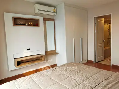 Modern bedroom with ensuite bathroom and sleek storage solutions