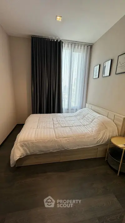 Modern bedroom with cozy bed and stylish decor in a well-lit apartment