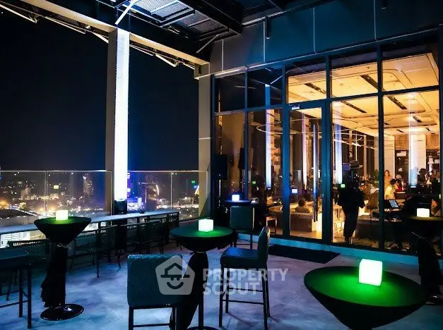 Stunning rooftop bar with panoramic city views and modern lighting, perfect for nightlife enthusiasts.