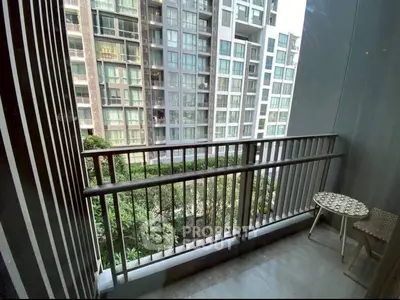 Modern apartment balcony with city view and stylish outdoor seating