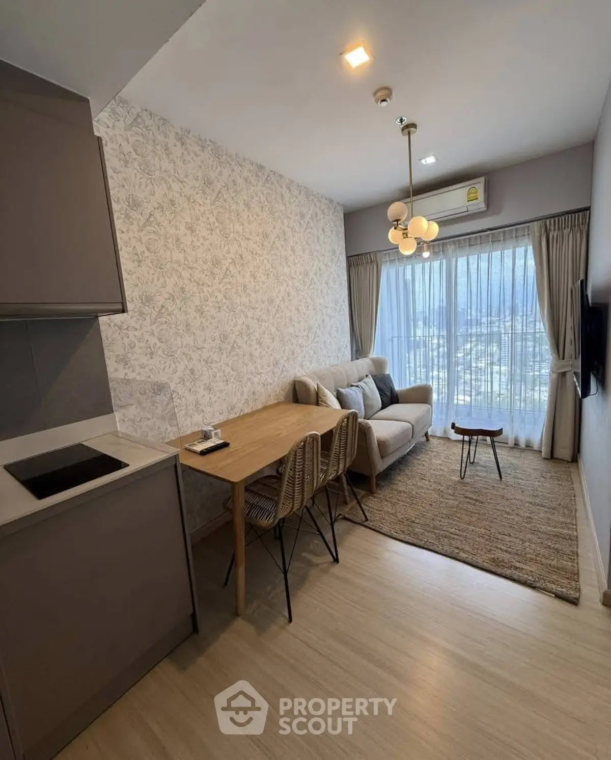 Modern living room with cozy sofa, dining area, and stylish decor in a high-rise apartment.