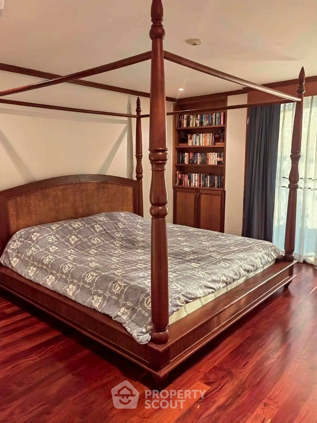 Luxurious bedroom with elegant four-poster bed and hardwood floors