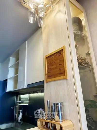 Modern kitchen with sleek cabinetry and cocktail menu board, perfect for entertaining.