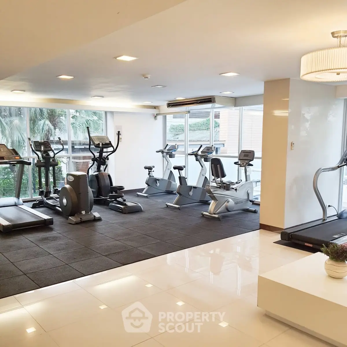 Modern gym with state-of-the-art equipment and bright natural lighting.