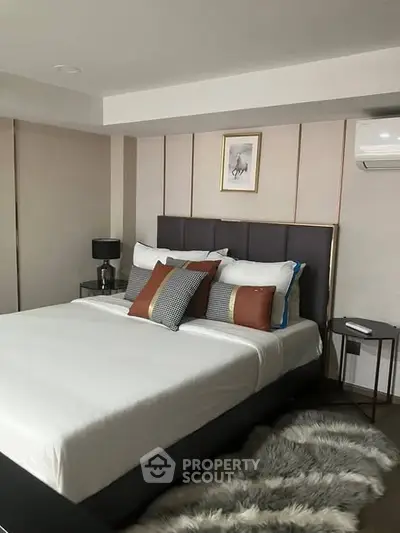 Luxurious modern bedroom with stylish decor and plush bedding