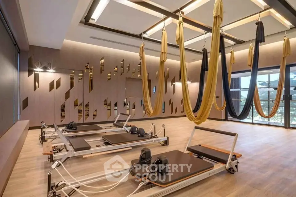 Luxurious gym with aerial yoga setup and modern decor