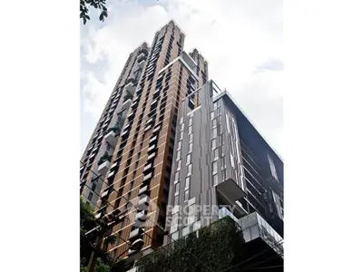 Stunning modern high-rise building with unique architectural design and lush greenery.