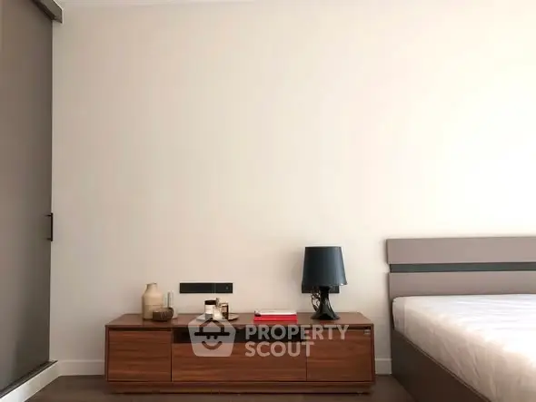 Modern bedroom with sleek wooden furniture and minimalist decor