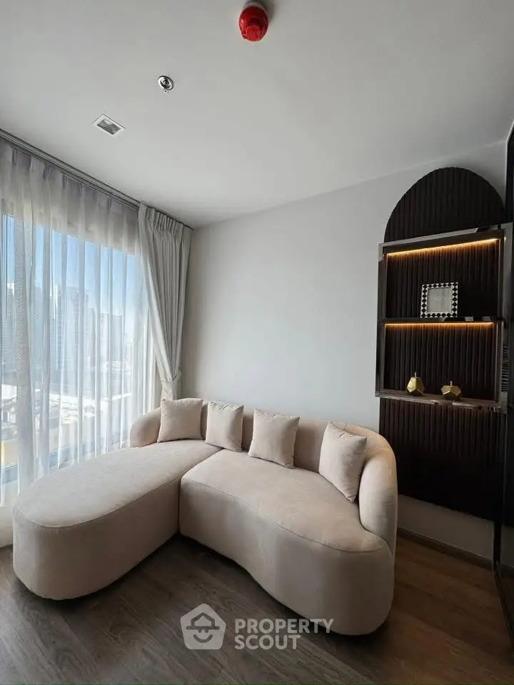 Modern living room with stylish sofa and city view, perfect for urban living.