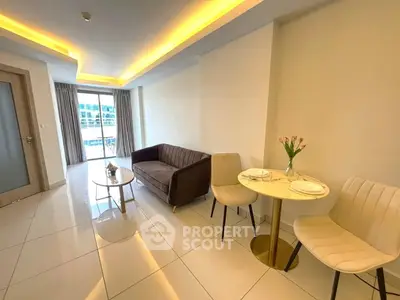 Modern living room with cozy sofa and elegant dining area, featuring large windows and stylish lighting.
