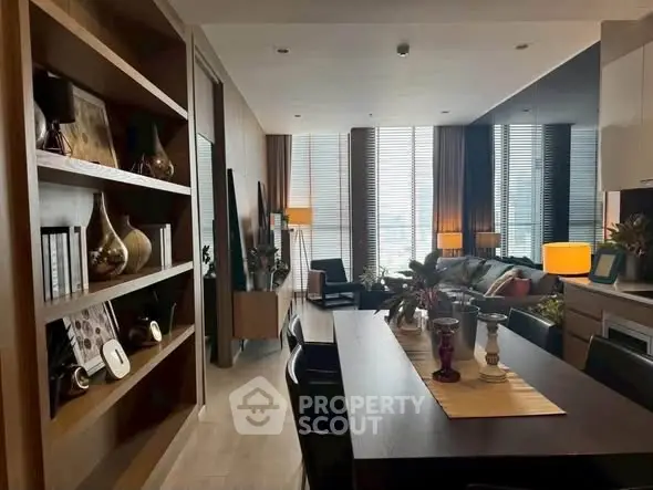 Luxurious modern living room with elegant dining area and floor-to-ceiling windows.