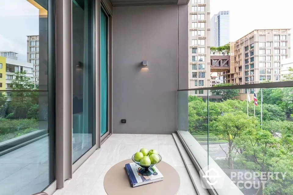 Modern balcony with glass railing and city view, perfect for relaxation.