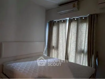 Cozy bedroom with air conditioning and natural light through curtains